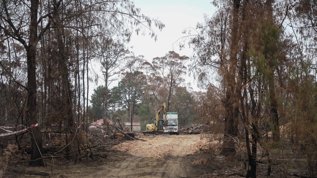 Crews work to clean-up debris in the fire-impacted community of Buxton, Australia, in January. The community lost several dozen homes during the recent blazes, and recovery work continues. (Lara Cooper/Direct Relief)