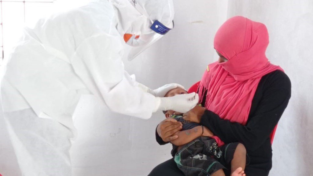 A health worker swabs a child, testing for Covid-19. (Photo courtesy of HOPE for Bangladesh)