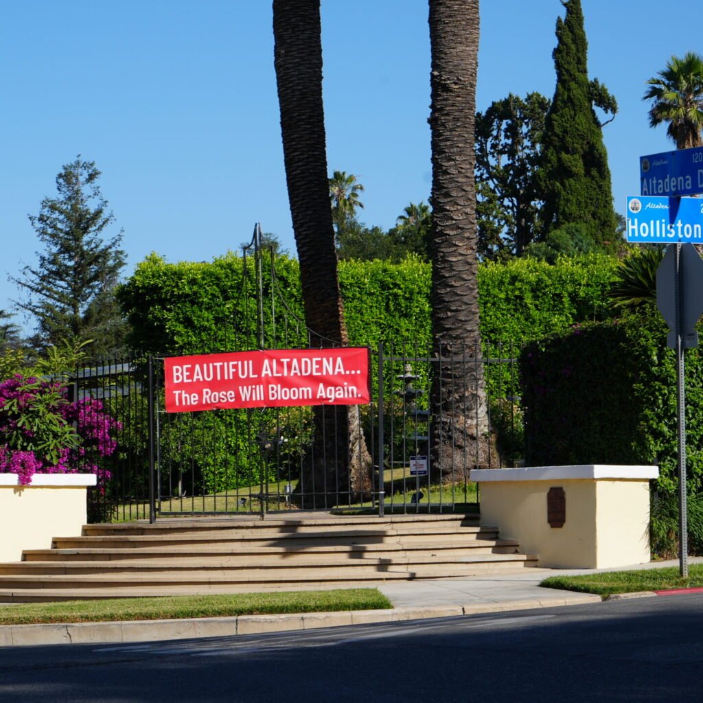 Banner in Altadena reads "Beautiful Altadena... The Rose Will Bloom Again"